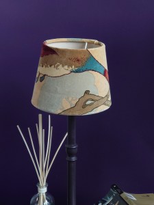 Bell shaped lampshade with duck breast and wing on a tall candlestick base